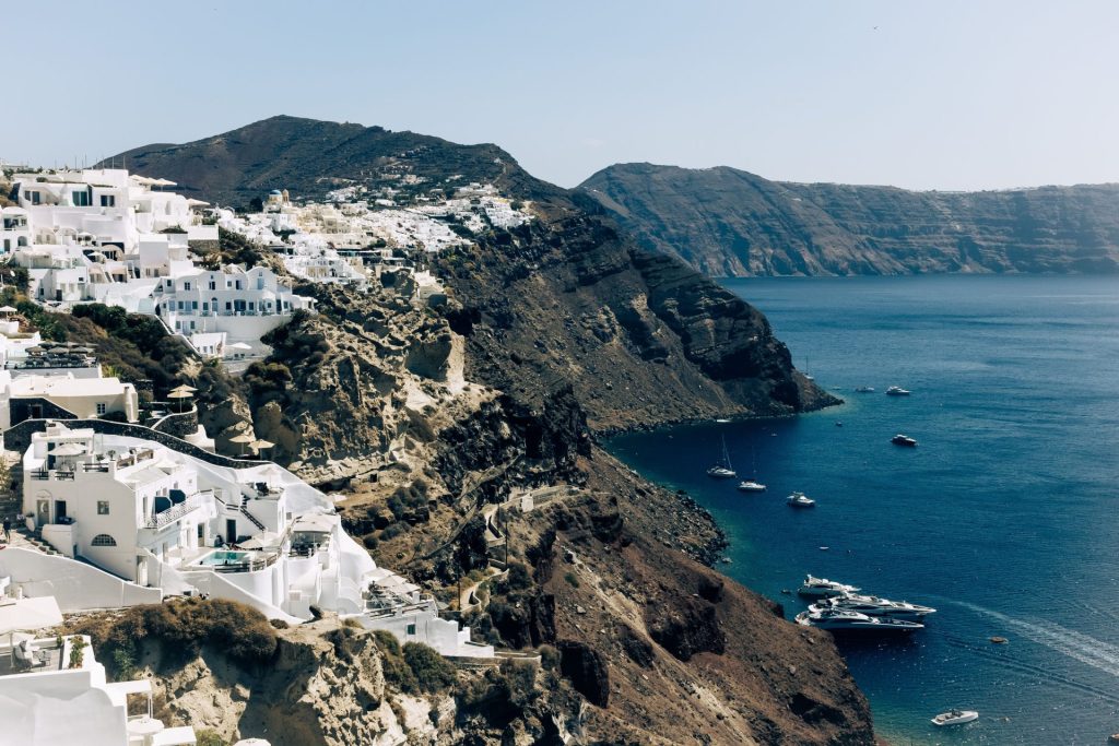 Breathtaking aerial view of Santorini's iconic white houses on cliffs overlooking the Aegean Sea.