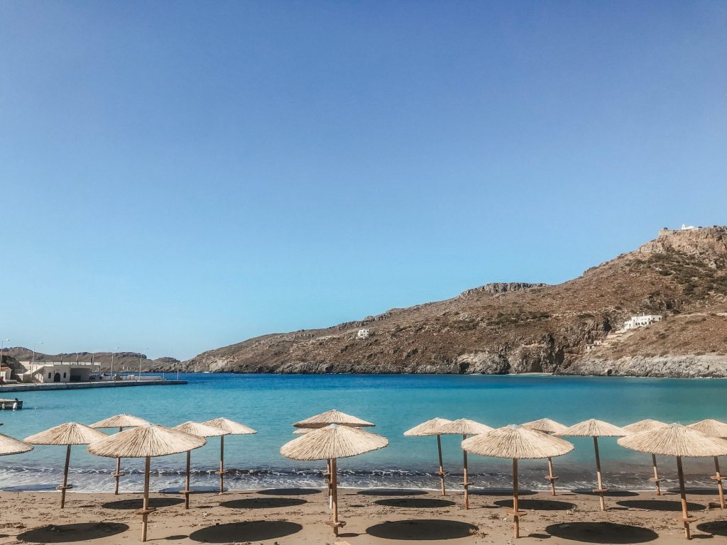 a bunch of umbrellas that are on a beach